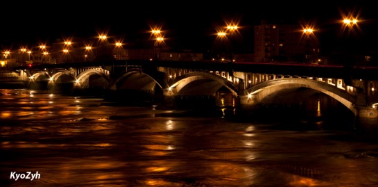Gold River under a stone bridge by night